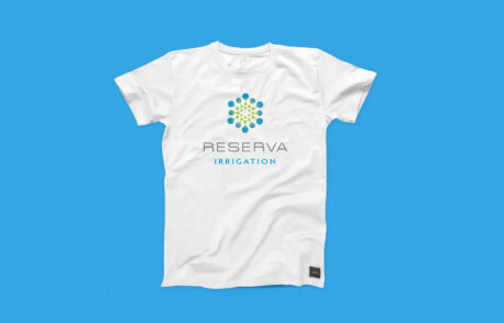 White T-shirt on blue background with the Reserva logo on it